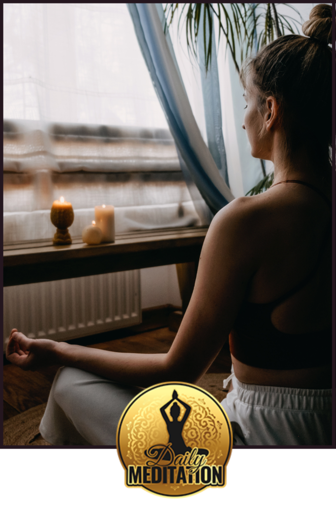 A woman practicing mindfulness in front of a window for her blog.